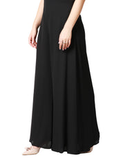 TUTA DONNA CARLA RUIZ NERA CON MAXI ROSA SULLO SCOLLO E PANTALONE CROPPED AMPIO