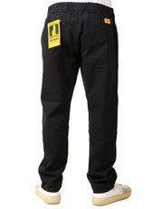 PANTALONE UOMO SERVICE WORKS NERO IN COTONE DRILL BIOLOGICO CON GAMBA A PALLONCINO E PIEGA DAVANTI